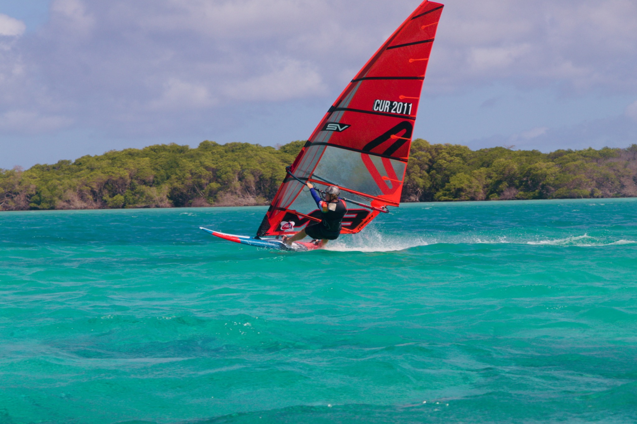 Thomas Cur racing across turquoise water